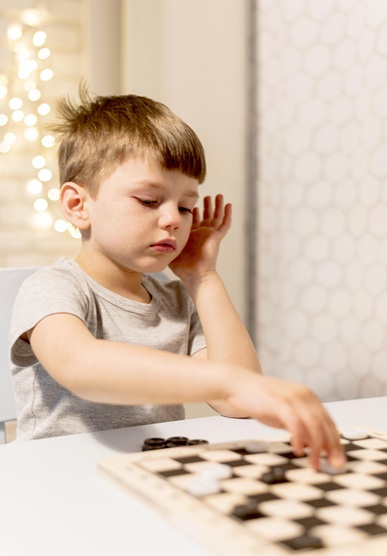 medium shot kid playing chess